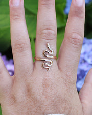 Adjustable Bronze Serpent Ring on left middle finger