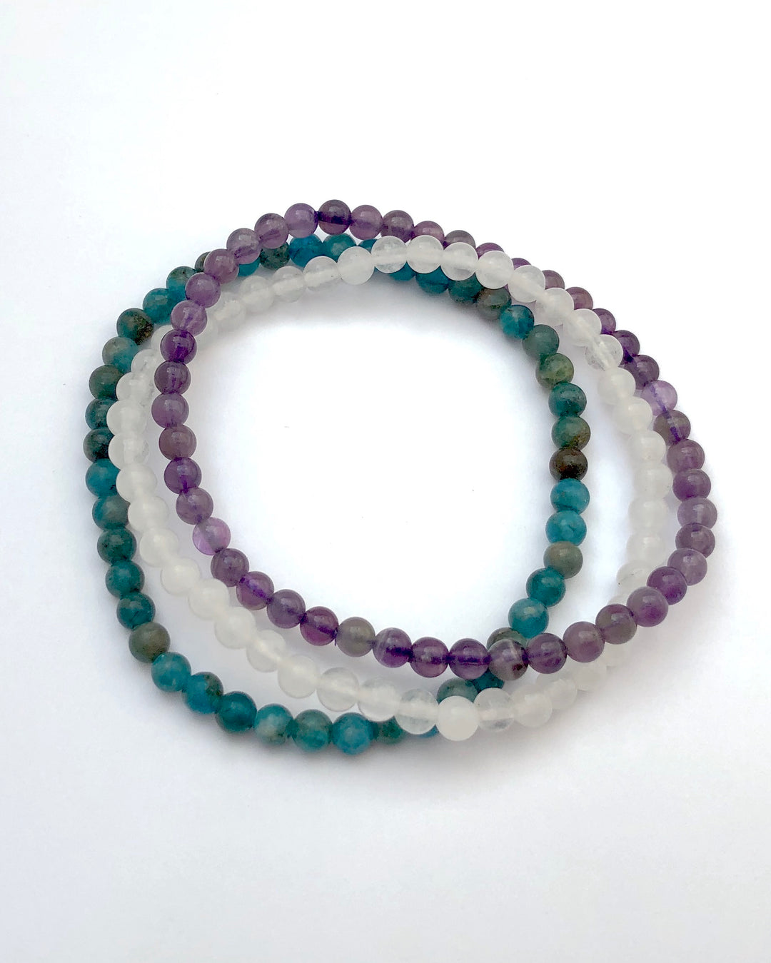 Amethyst, Snow Quartz and Apatite 4mm beaded Bracelet Set for Balance and Clarity on White background.