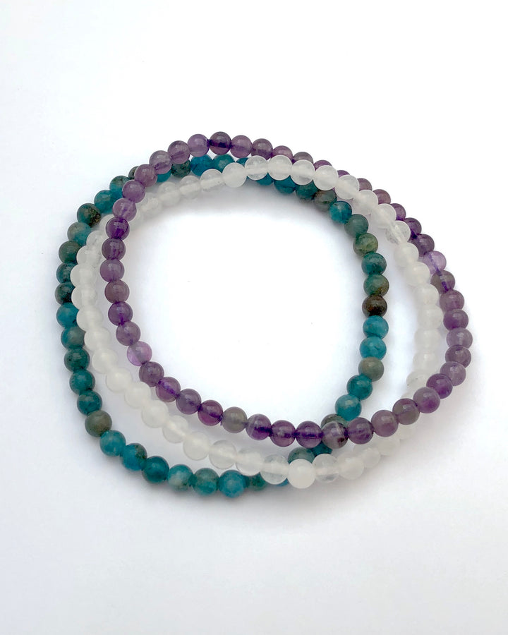 Amethyst, Snow Quartz and Apatite 4mm beaded Bracelet Set for Balance and Clarity on White background.