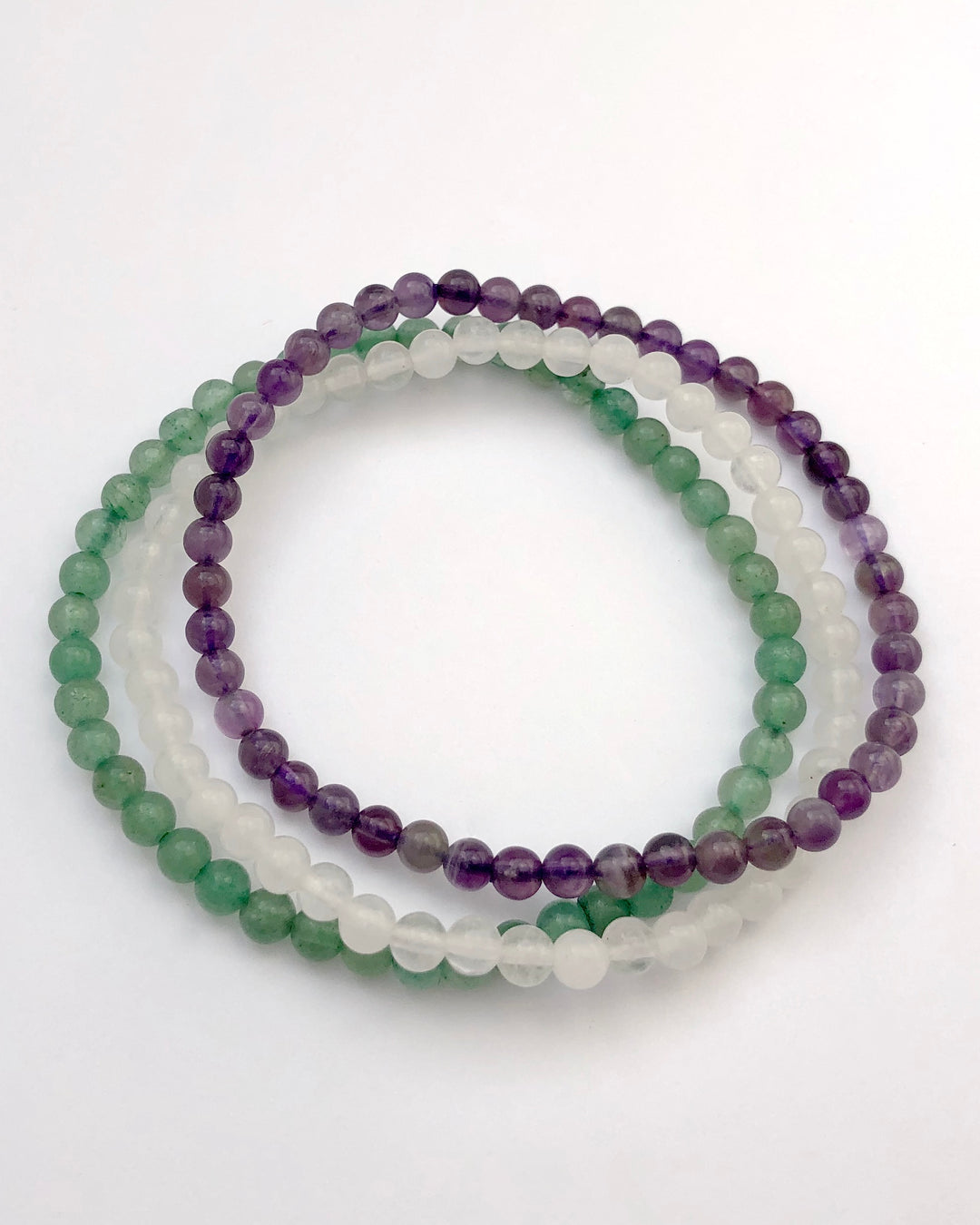 Amethyst, Snow Quartz and Aventurine Crystal Bracelet Set for Tranquility on a white background
