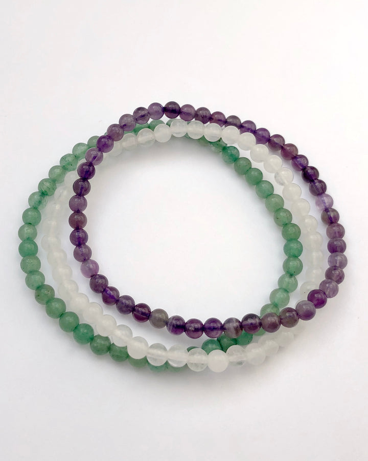 Amethyst, Snow Quartz and Aventurine Crystal Bracelet Set for Tranquility on a white background