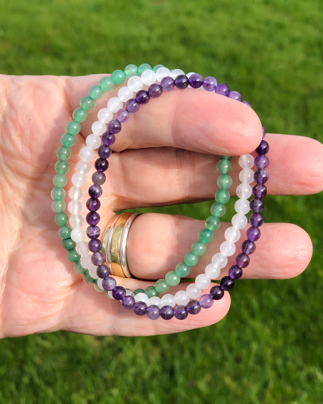 Amethyst, Snow Quartz and Aventurine Crystal Bracelet Set for Tranquility in a hand