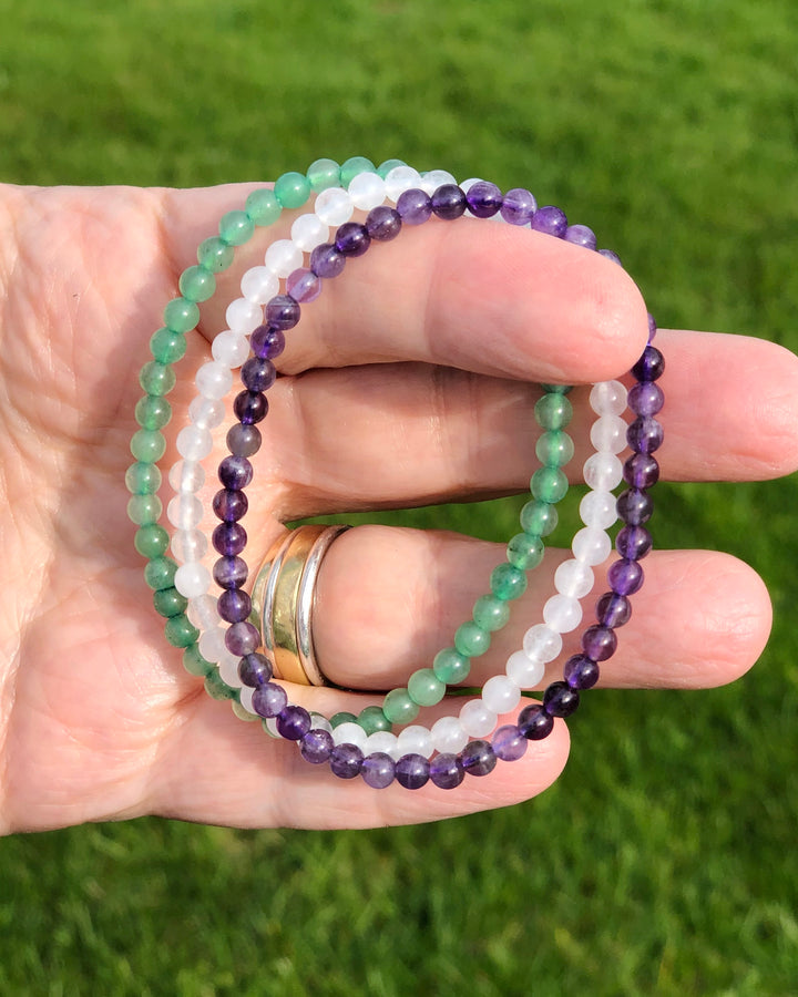 Amethyst, Snow Quartz and Aventurine Crystal Bracelet Set for Tranquility in a hand