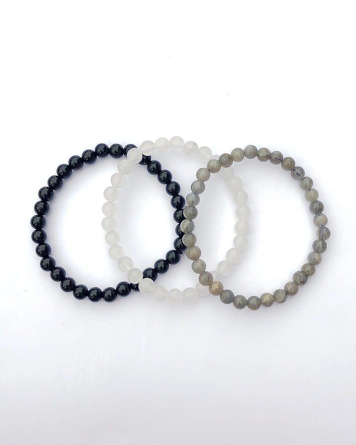 Amethyst, Snow Quartz and Labradorite 6mm beaded Gemstone Bracelet Set for Peaceful Transformation on a white background.
