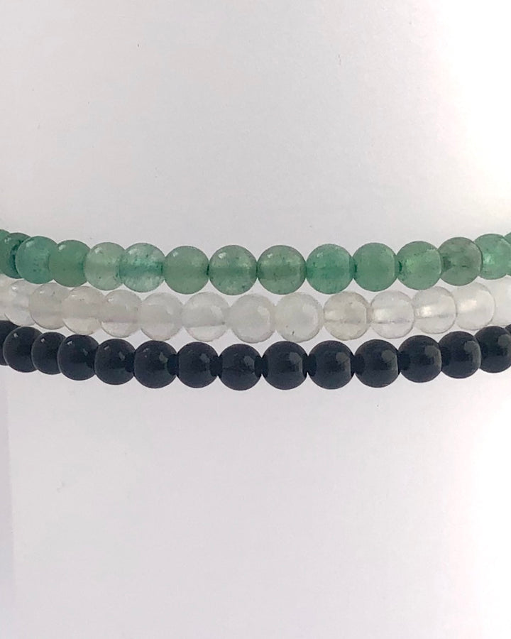 Aventurine, Snow Quartz and Black Agate stacked bracelets.