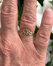 gold vermeil lotus ring on right ring finger white flower background
