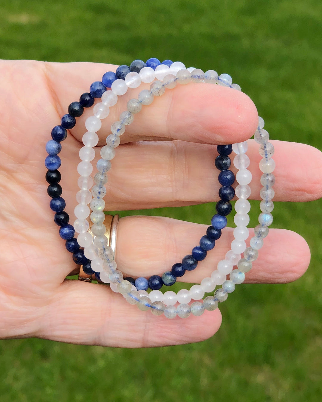 Labradorite, Snow Quartz and Lapis Lazuli  bracelets in a hand