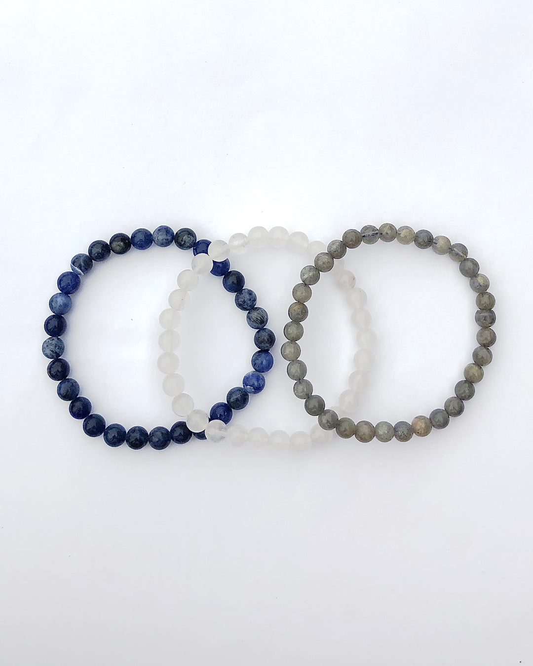 Labradorite, Snow Quartz and Lapis Lazuli 6mm beaded Gemstone Bracelet Set for Divine Intuition on a white background.