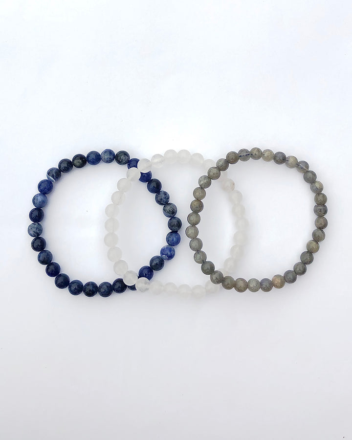 Labradorite, Snow Quartz and Lapis Lazuli 6mm beaded Gemstone Bracelet Set for Divine Intuition on a white background.