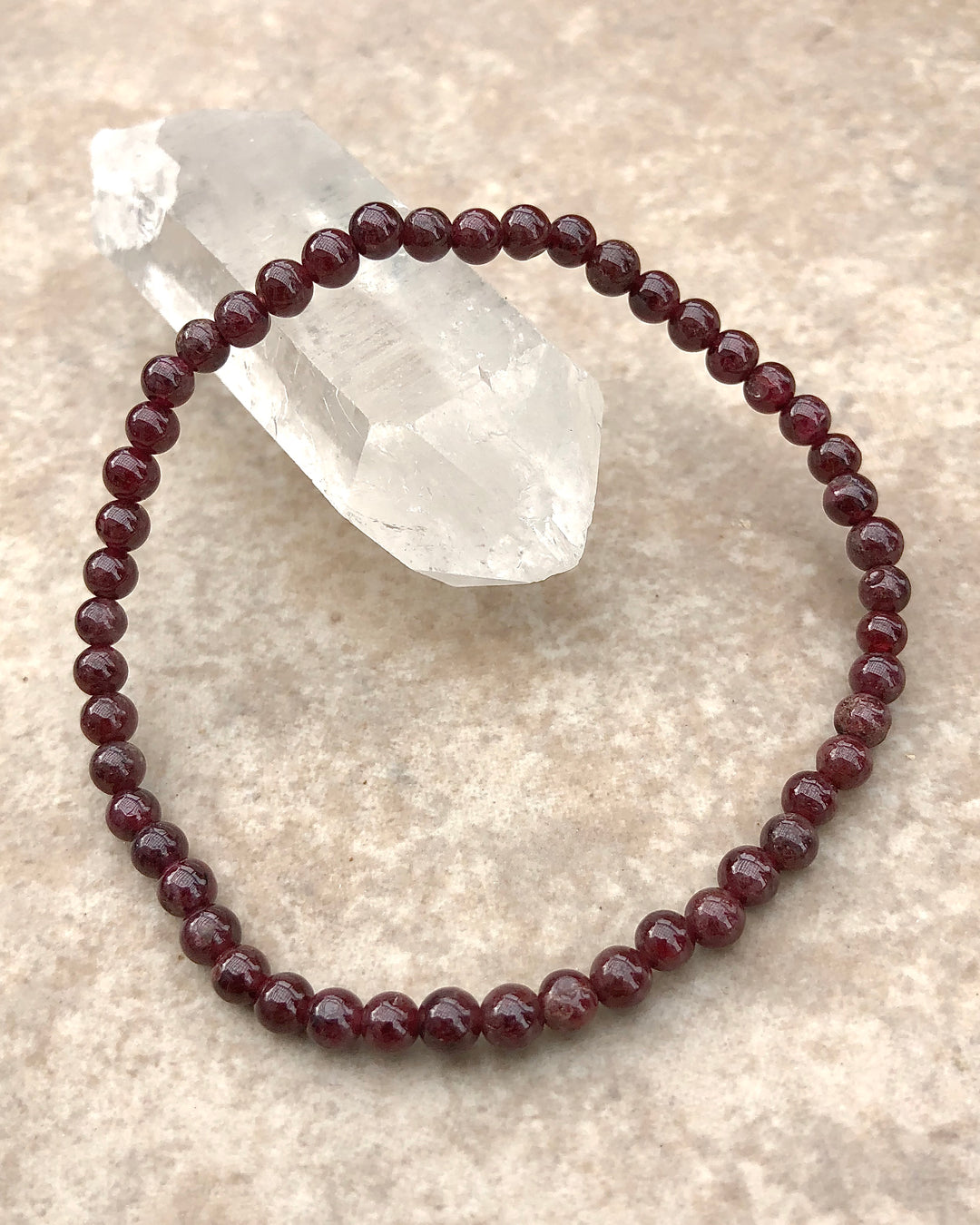 Garnet 4mm Beaded Gemstone Bracelet on a crystal