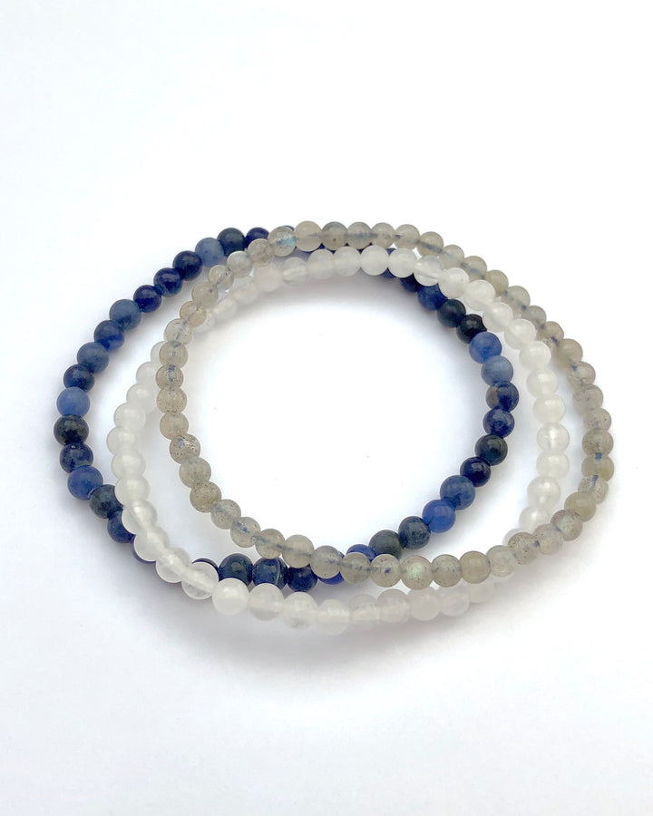 Labradorite, Snow Quartz and Lapis Lazuli Bracelets on a White Background