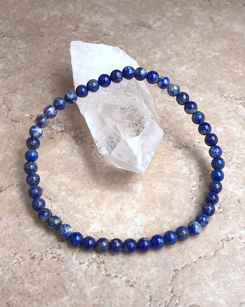 Lapis Lazuli 4mm Beaded Gemstone Bracelet  on a crystal.