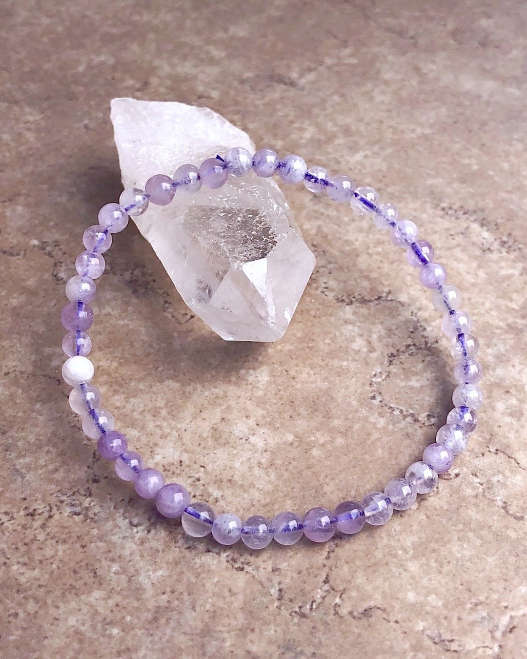 Lavender Amethyst 4mm Beaded Gemstone Bracelet on a crystal.