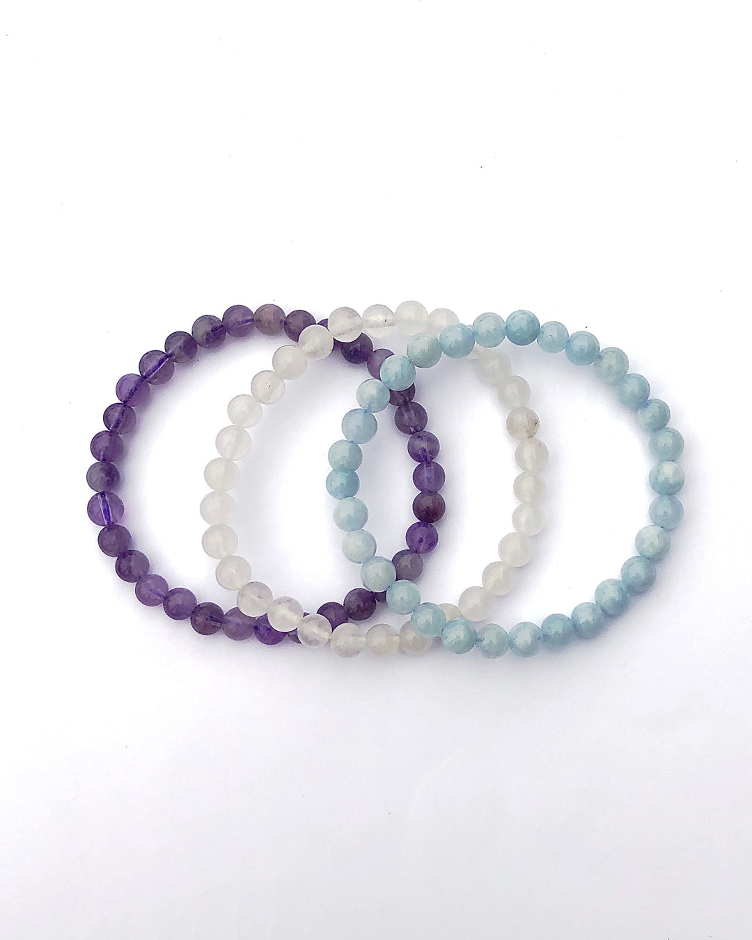 Lavender Amethyst, Snow Quartz and Aquamarine 6mm Beaded Gemstone Bracelet Set for Serenity and Wellness on a white background.
