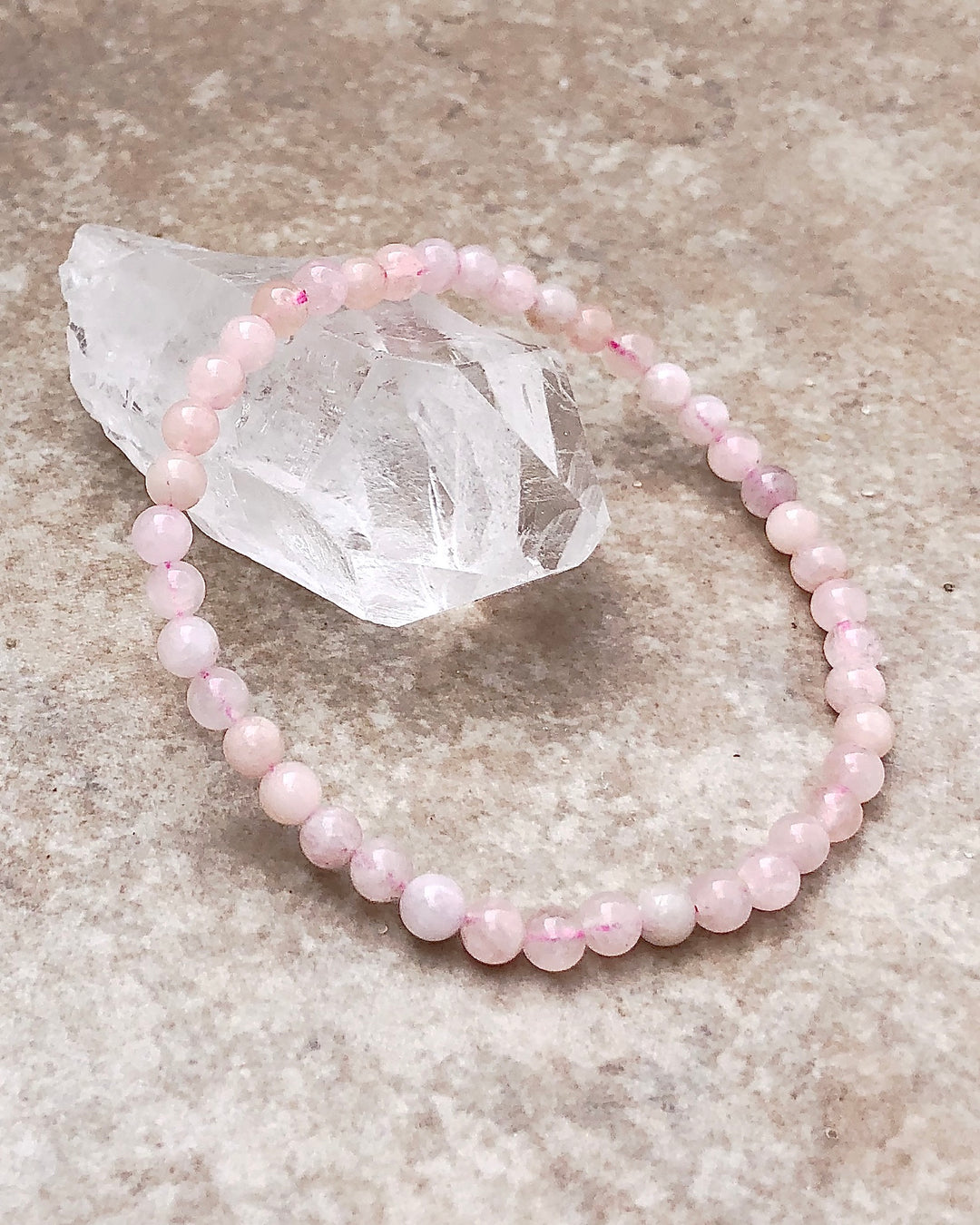 Morganite 4mm Beaded Gemstone Bracelet on a crystal.