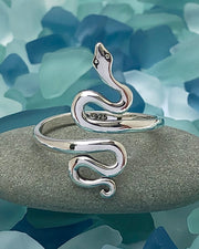 Silver Serpent Ring with sea glass in background