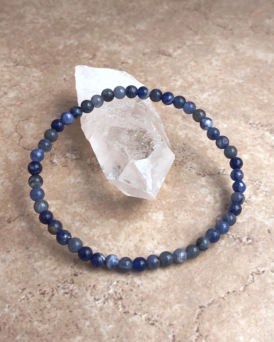 Sodalite 4mm Beaded Gemstone Bracelet on a crystal.