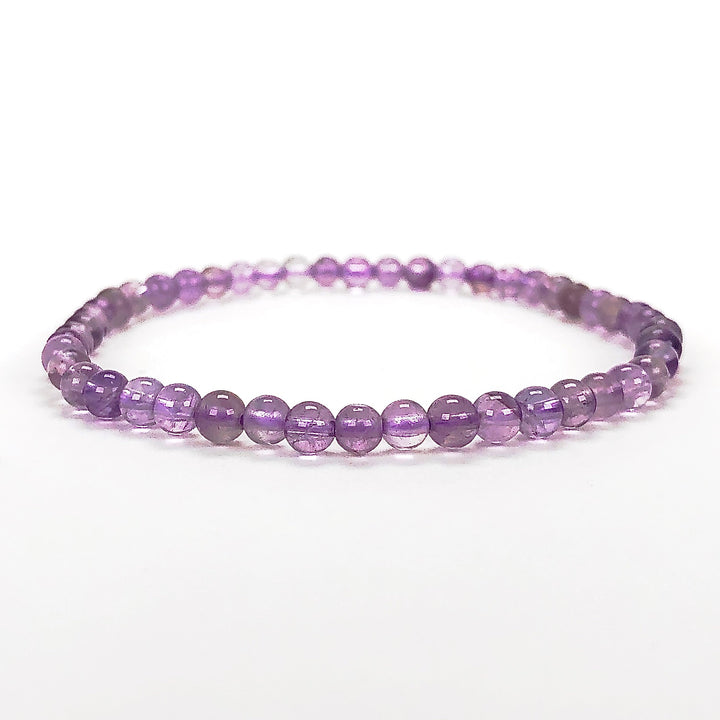 Lavender Amethyst 4mm Beaded Gemstone Bracelet on a wide background.