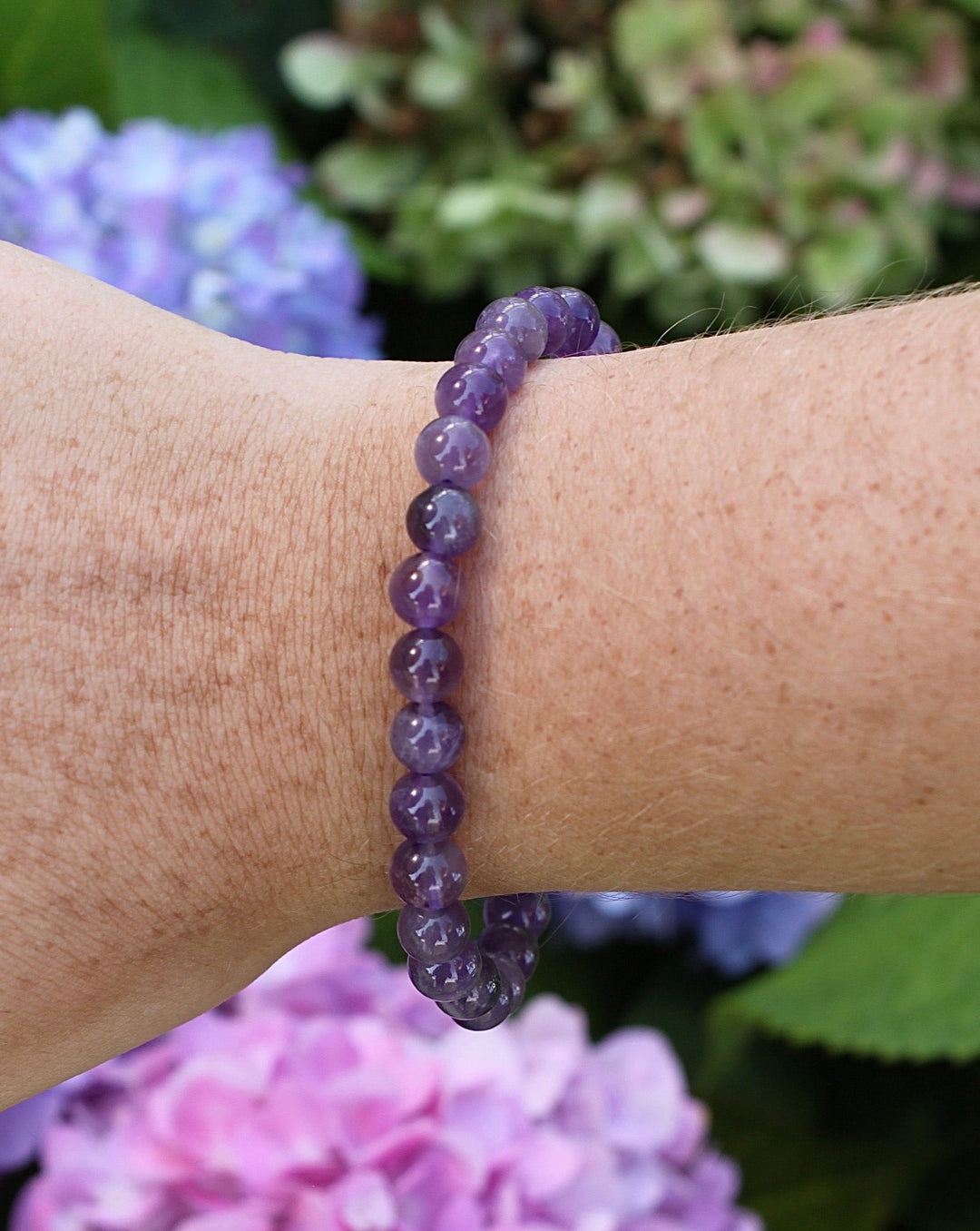 Amethyst 6mm Beaded Gemstone Bracelet on a wrist