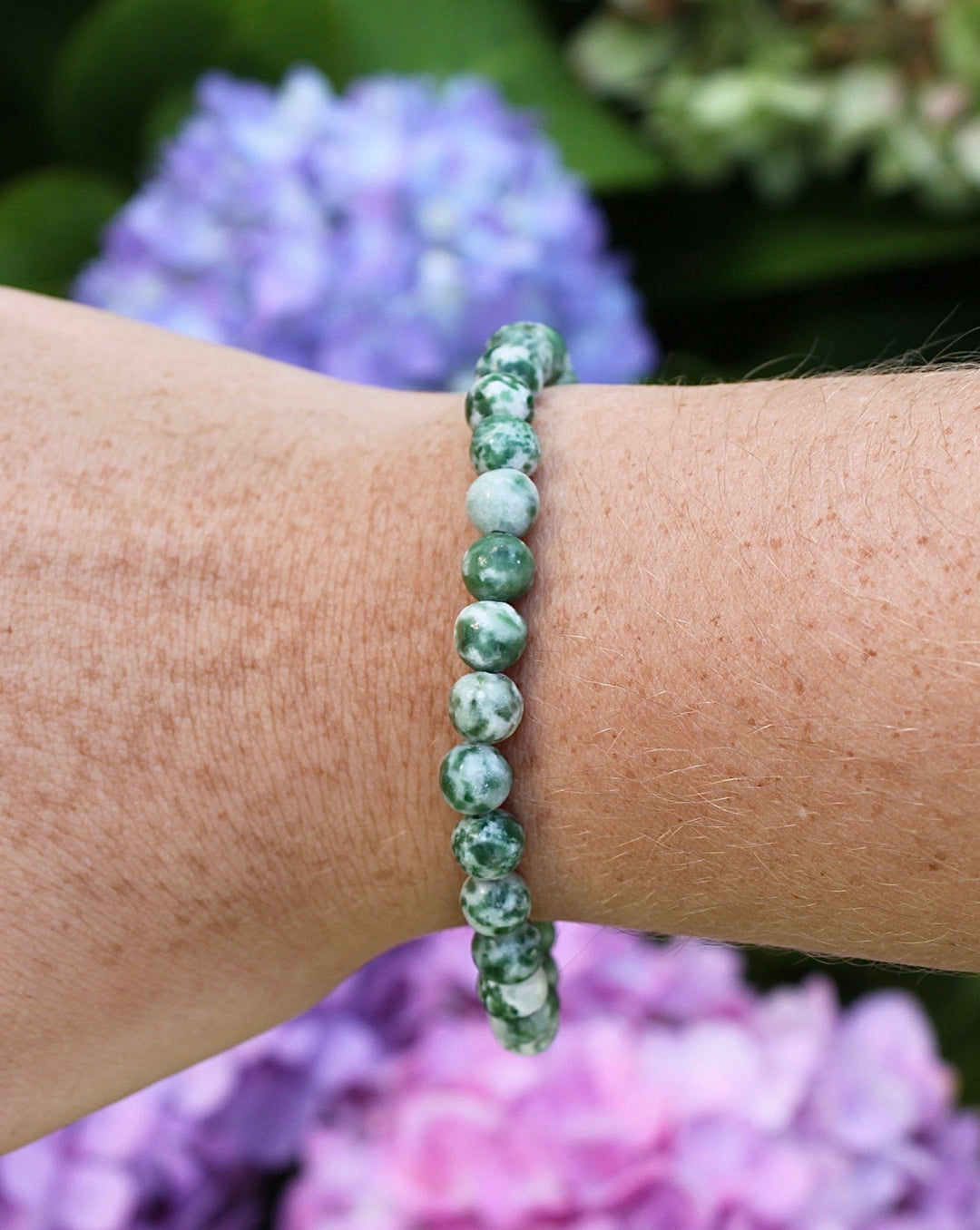 Natural Green Jade 6mm Beaded Gemstone Bracelet on a wrist.