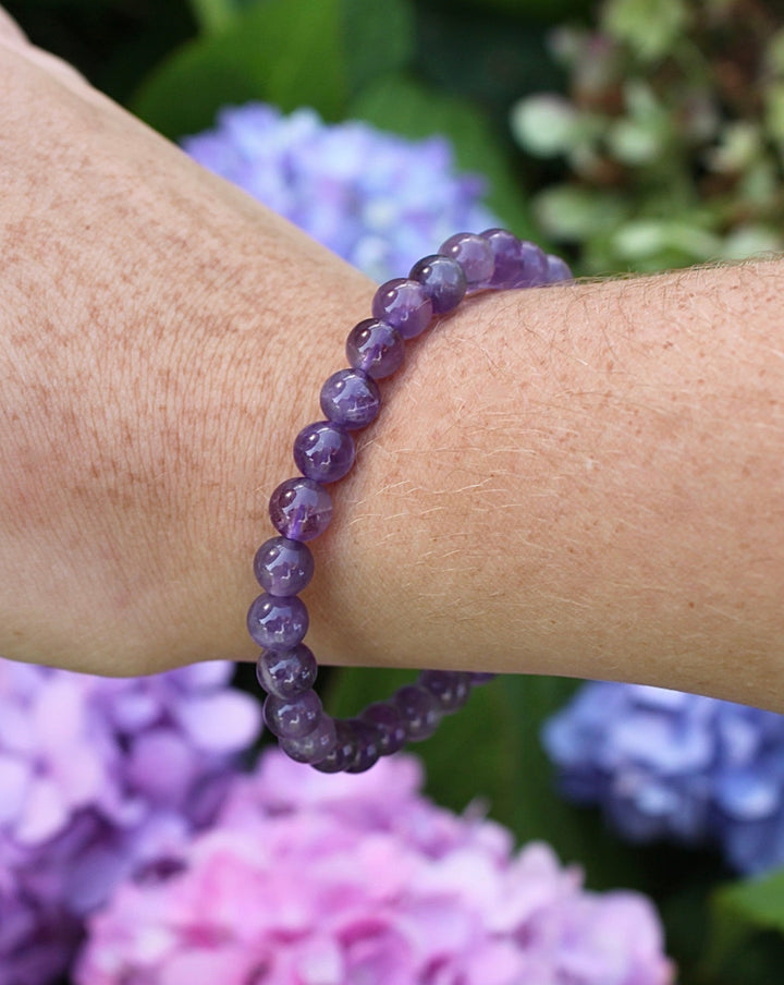 Amethyst 6mm Beaded Gemstone Bracelet on a wist with flowers