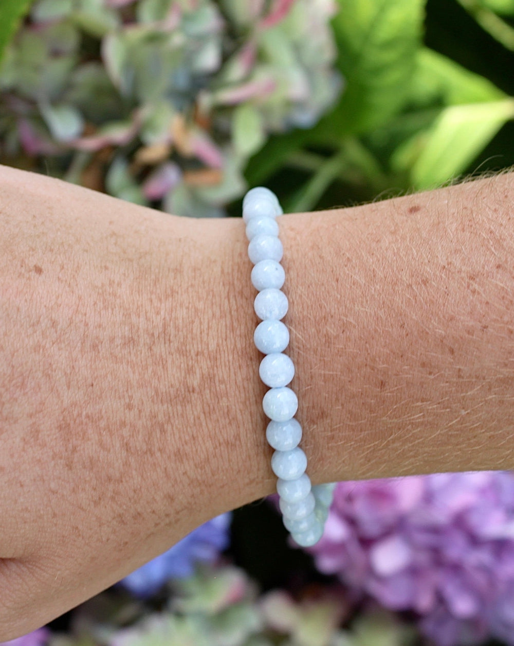 Aquamarine 6mm Beaded Gemstone Bracelet on a wrist.