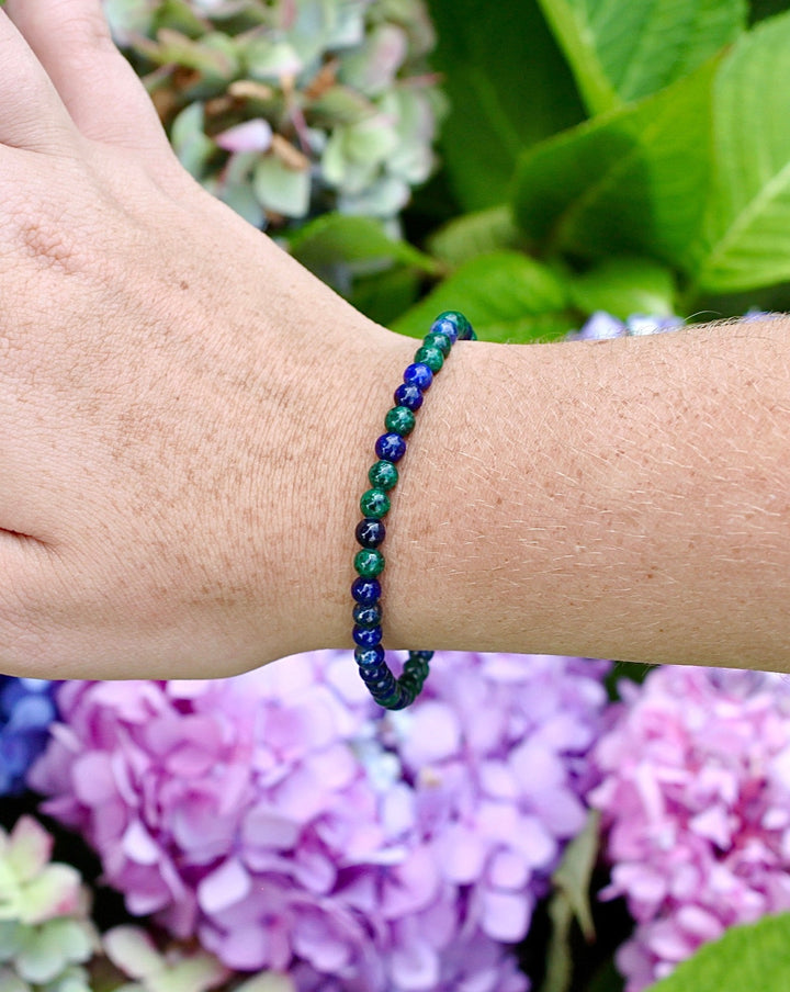 Aventurine 4mm Gemstone Bracelet on a Wrist with Background Flowers