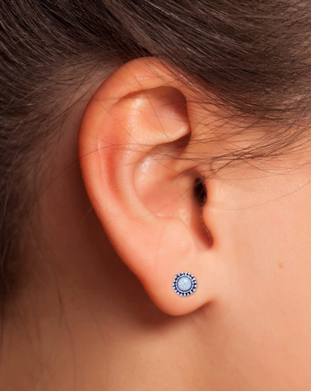 Bali Style White Lab Opal Sterling Silver Stud Earrings on a ear.