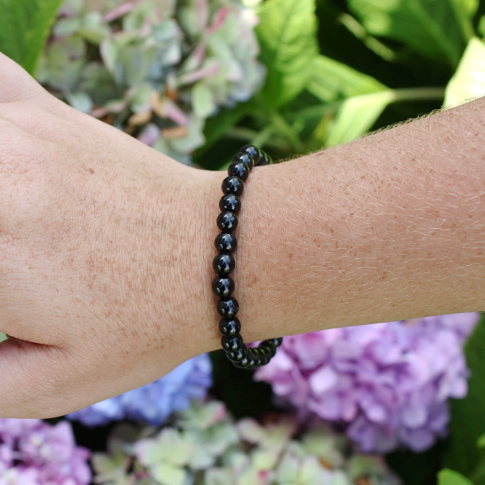 Black Agate 6mm Beaded Gemstone Bracelet on a wrist.