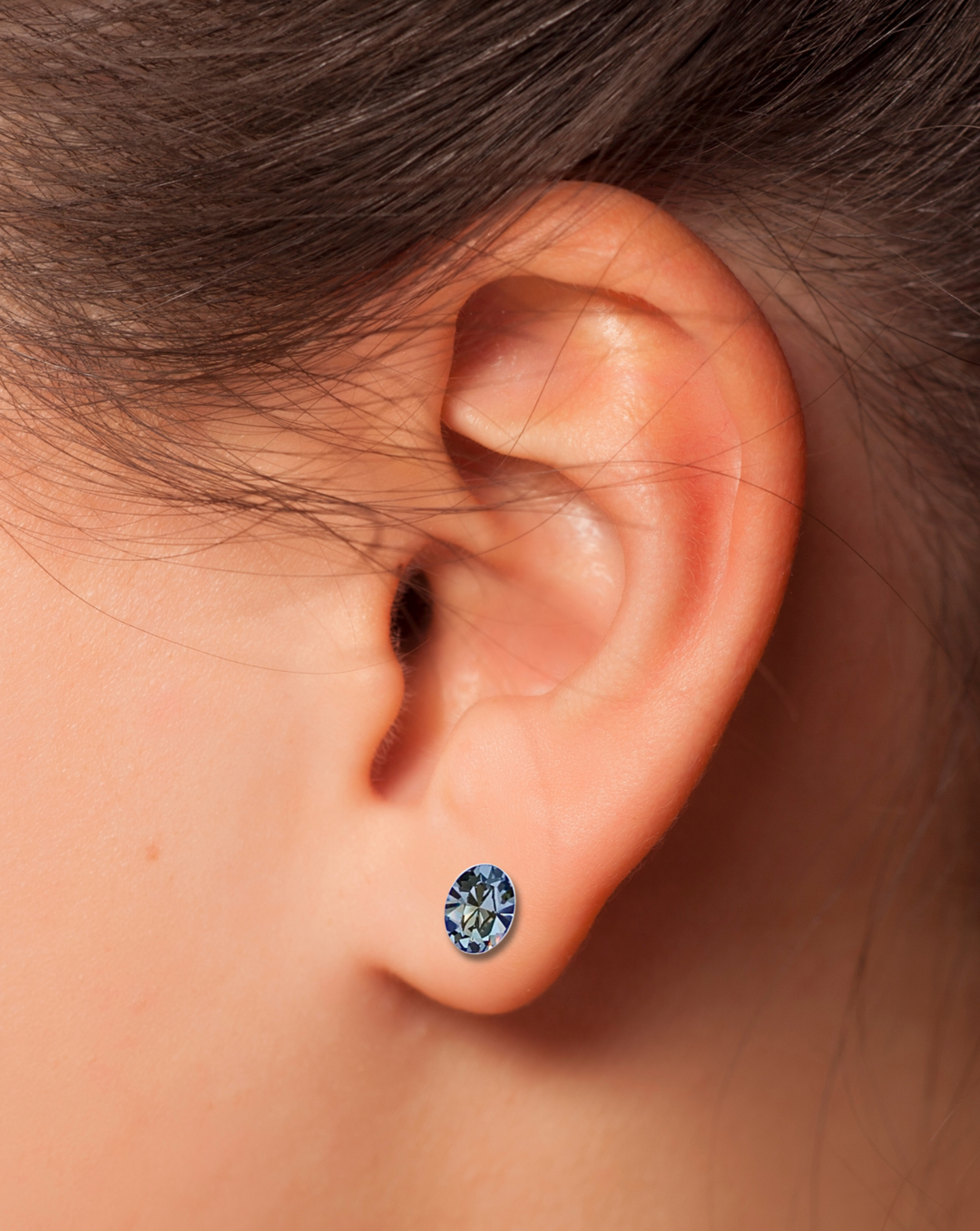 Black Diamond Oval CZ Sterling Silver Stud Earring on an ear.