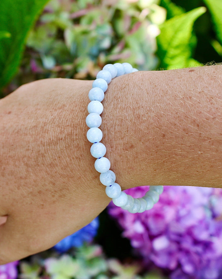 Blue Lace Agate 6mm Beaded Gemstone Bracelet on a wrist.