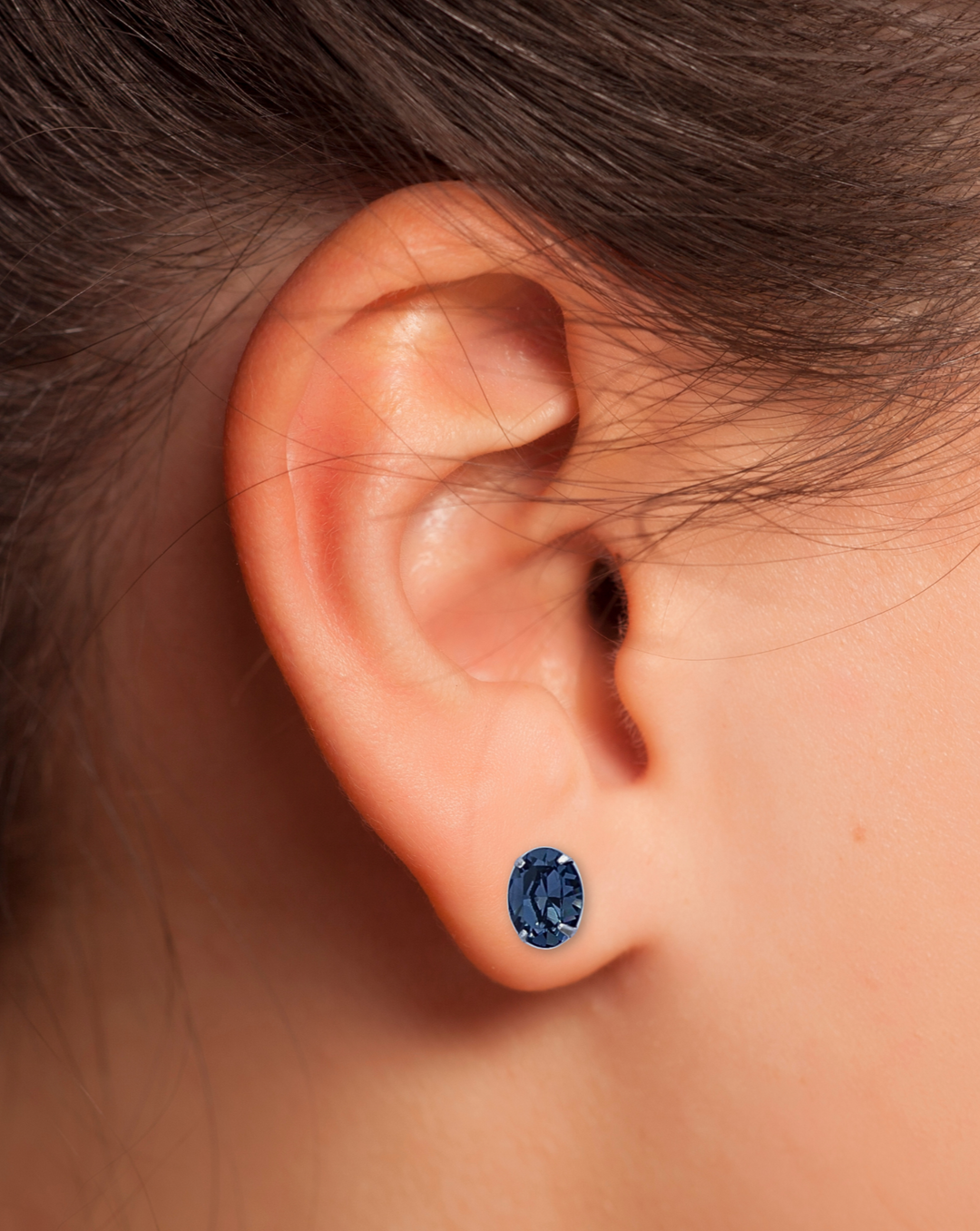 Blue Oval CZ Sterling Silver Earring on an Ear