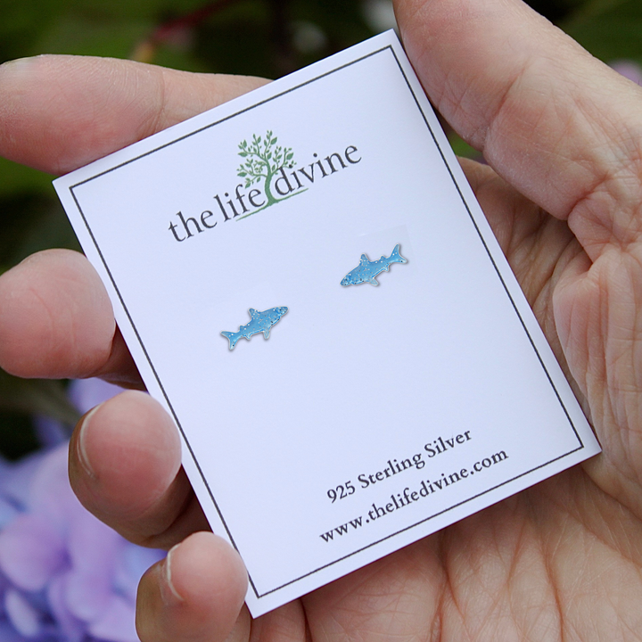 Blue Shark Sterling Silver Stud Earrings  on a card being held.