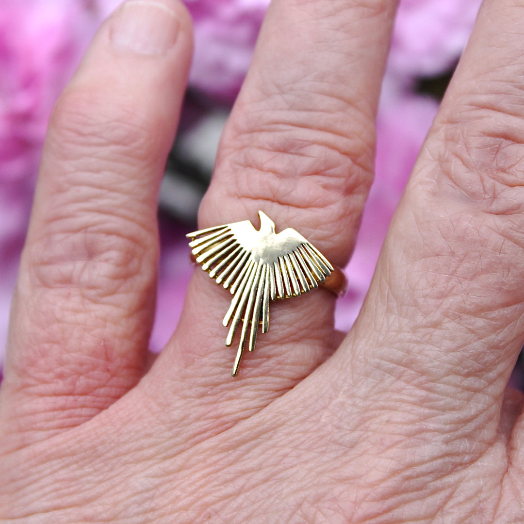 Brass Phoenix Ring on a finger