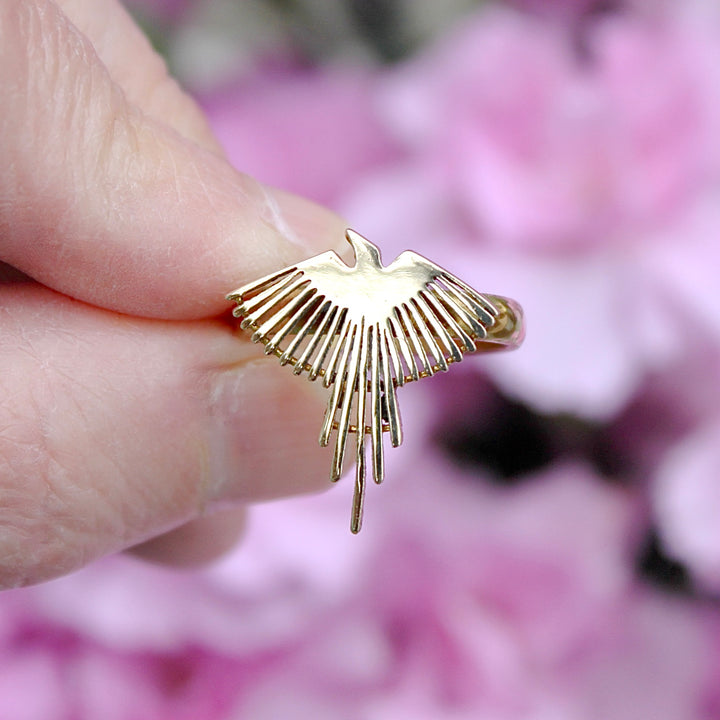 Holding Brass Phoenix Ring between fingers