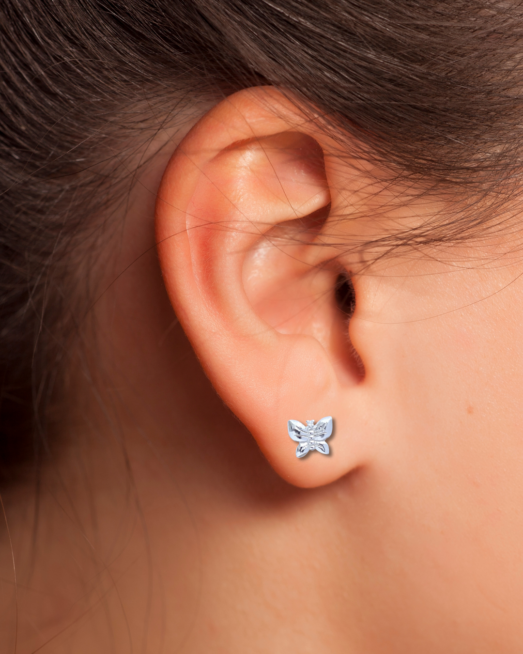 Butterfly Sterling Silver Stud Earring on an ear.