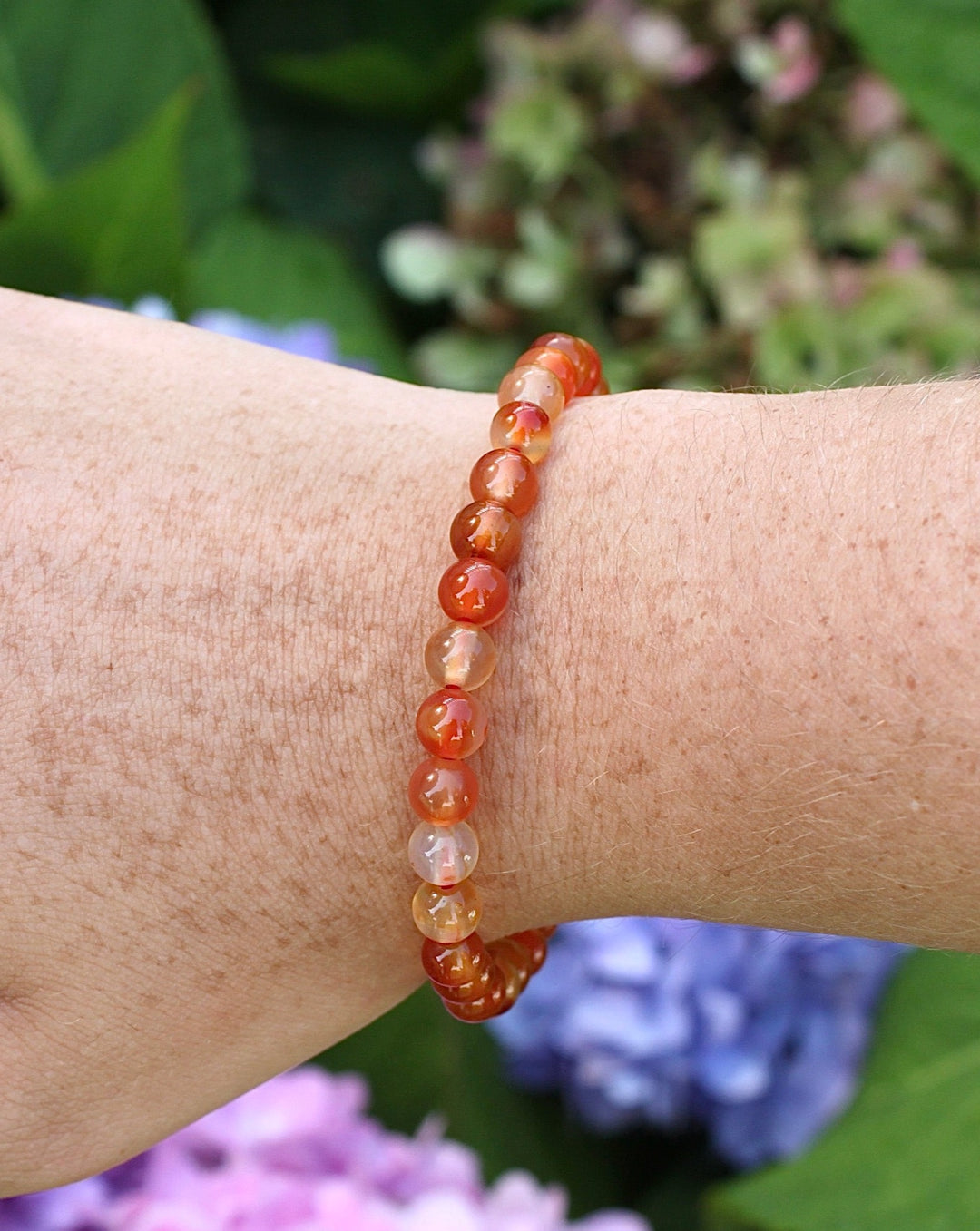 Carnelian 6mm Beaded Gemstone Bracelet on a wrist.