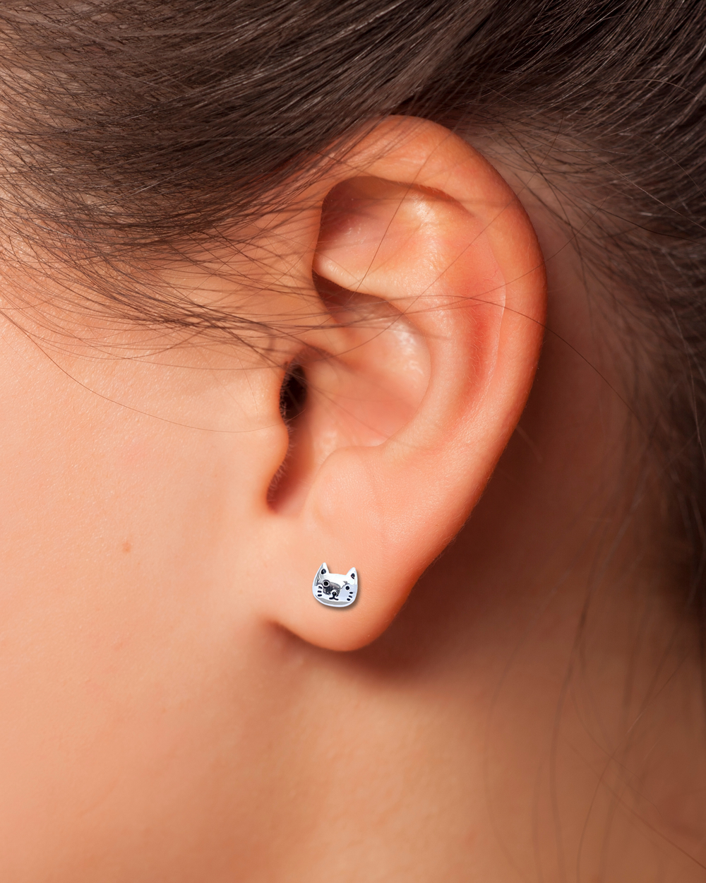 Cat Face Sterling Silver Stud Earring on an ear.