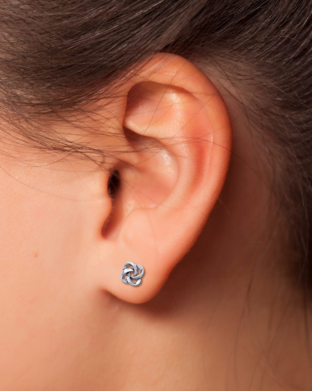 Celtic Knot Sterling Silver Earrings on an Ear.