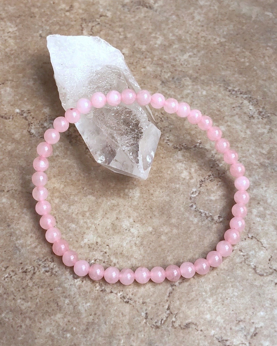 Children's Rose Quartz 4mm Gemstone Bracelet on a crystal