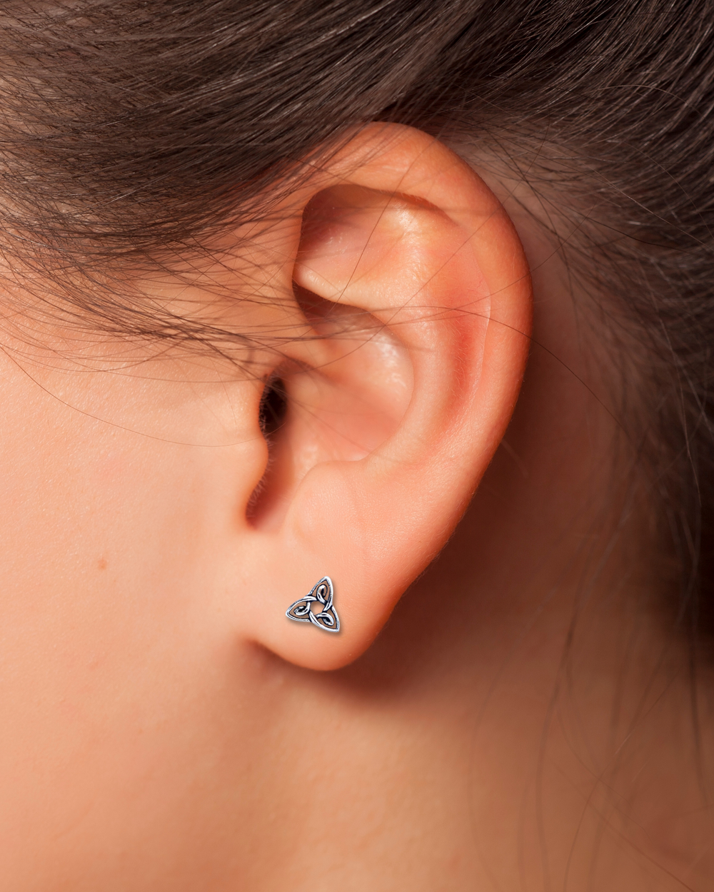 Detailed Triquetra Sterling Silver Earrings on ear