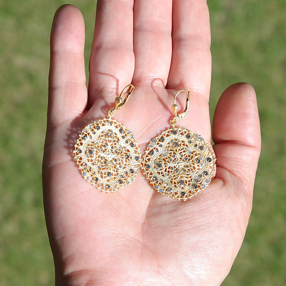 Filigree Medallion Crystal Earrings in a Hand.