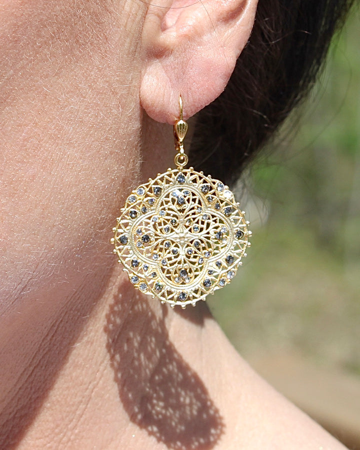 Filigree Medallion Crystal Earring on an Ear.