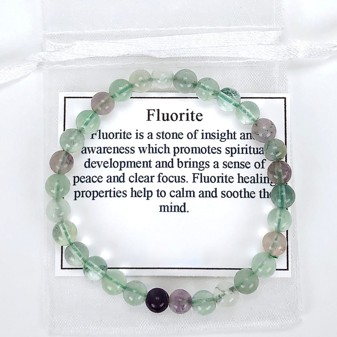 Fluorite 6mm Beaded Gemstone Bracelet with a description card.