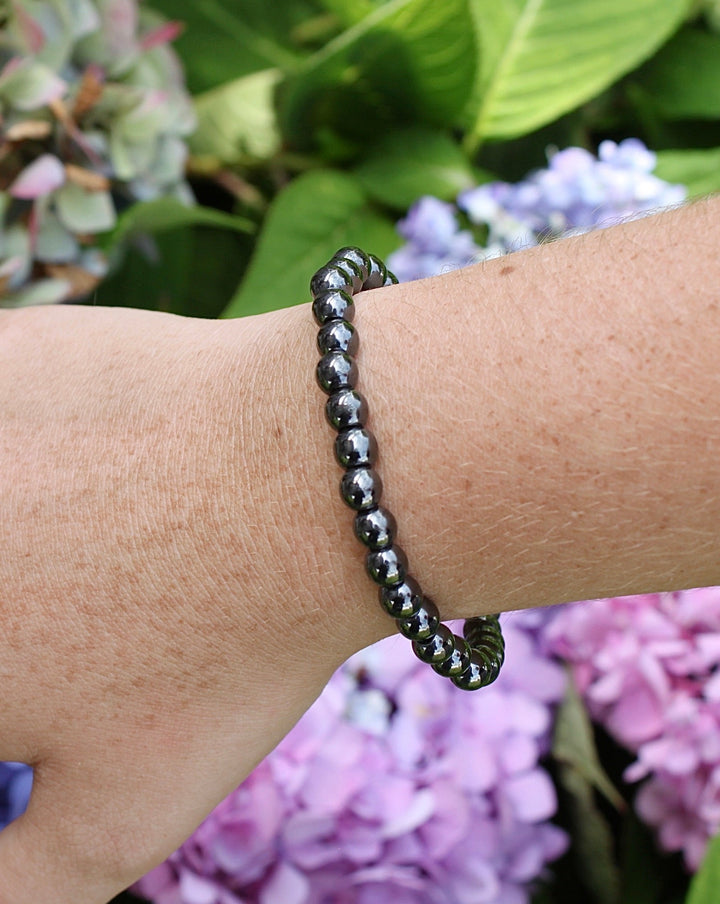 Hematite 6mm Beaded Gemstone Bracelet on a wrist.