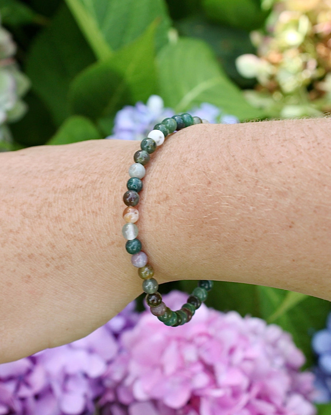 Indian Agate 4mm Beaded Gemstone Bracelet on a wrist with flowers