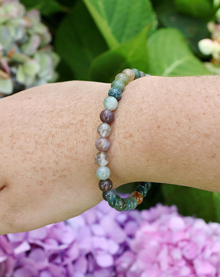 Indian Agate 6mm Beaded Gemstone Bracelet on a wrist with flowers