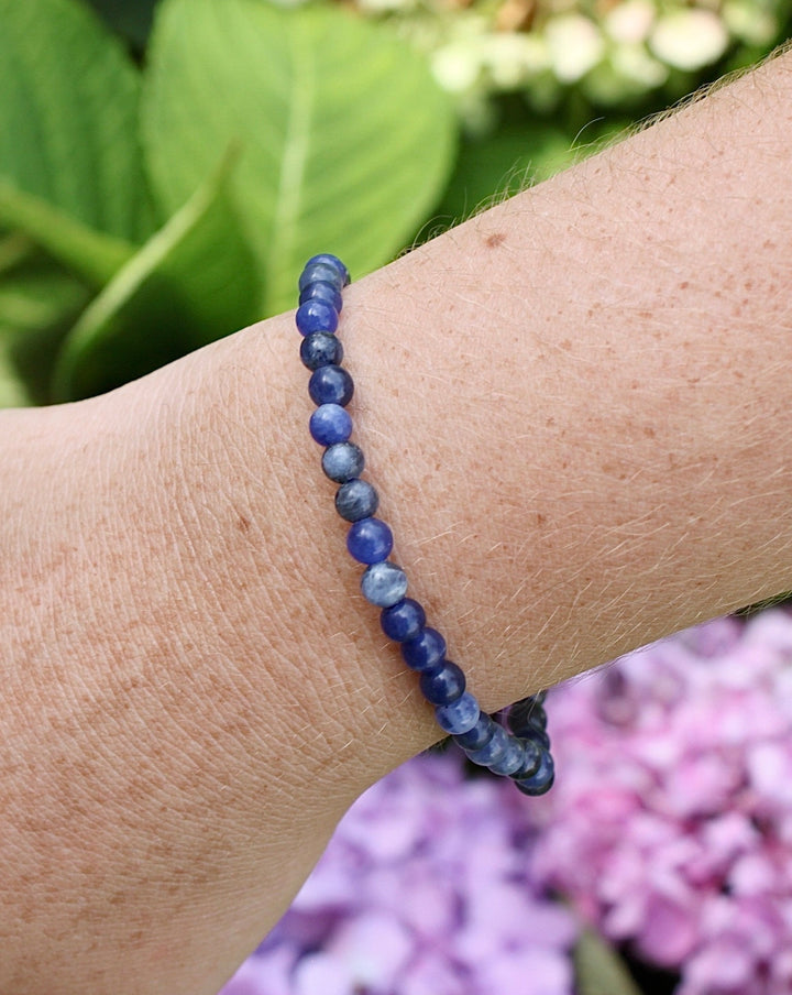 Lapis Lazuli 4mm Beaded Gemstone Bracelet on a wrist.