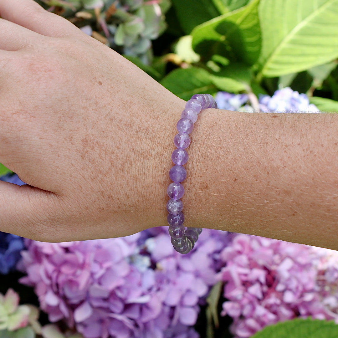 Lavender Amethyst 6mm Beaded Gemstone Bracelet on a wrist.