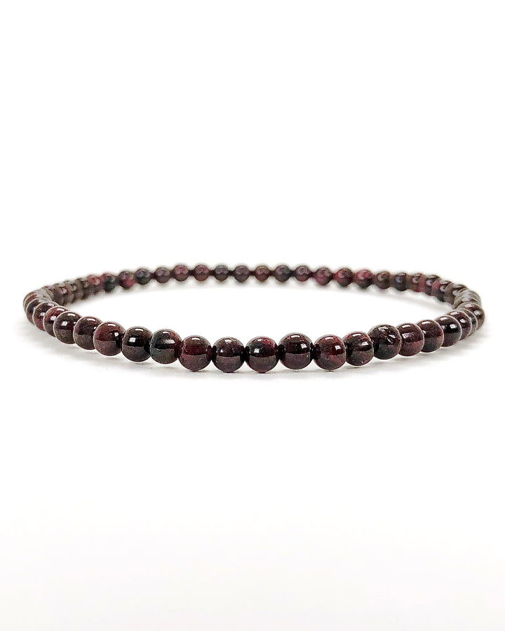 Men's Garnet 4mm Beaded Gemstone Bracelet on a wide Background